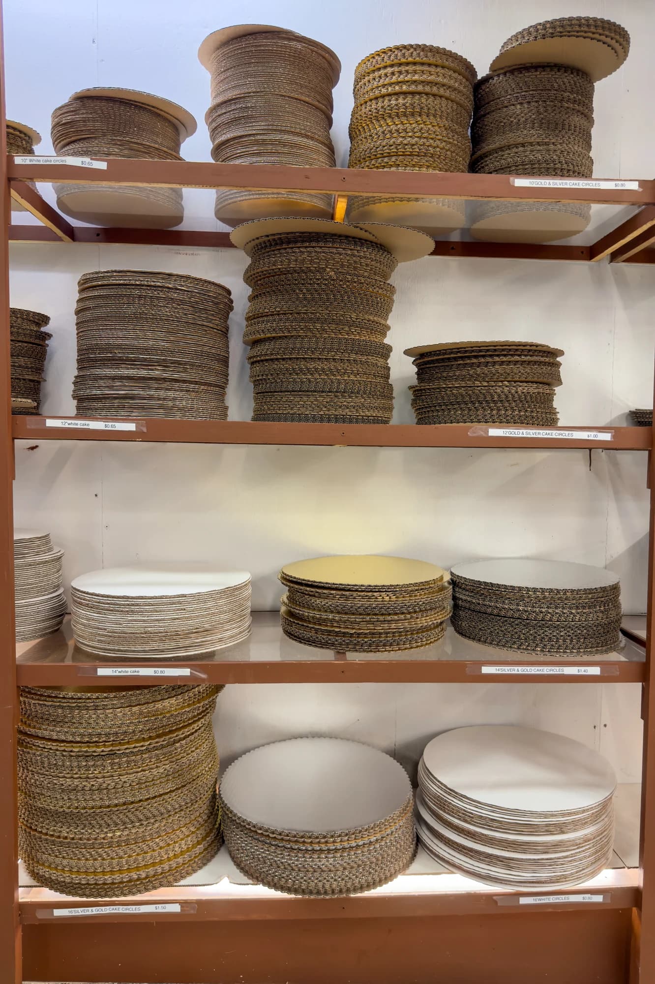 White and gold cake boards on Ralph’s shelves