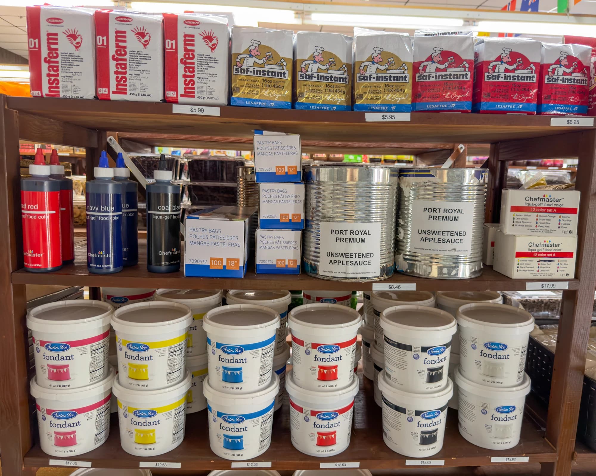 Yeast, food coloring, pastry bags, and fondant on Ralph’s baking shelves